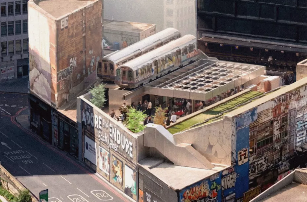 Open-air terrace with pergola seating next to repainted graffiti tube carriages in London
