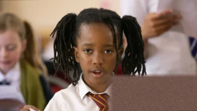 Children singing in a church choir rehearsal in south London