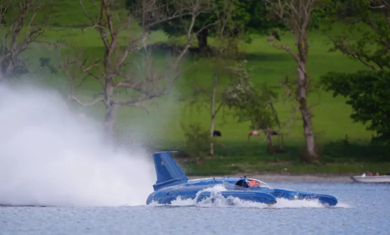 Restored Bluebird K7 hydroplane moving across Coniston Water at the Lake District festival