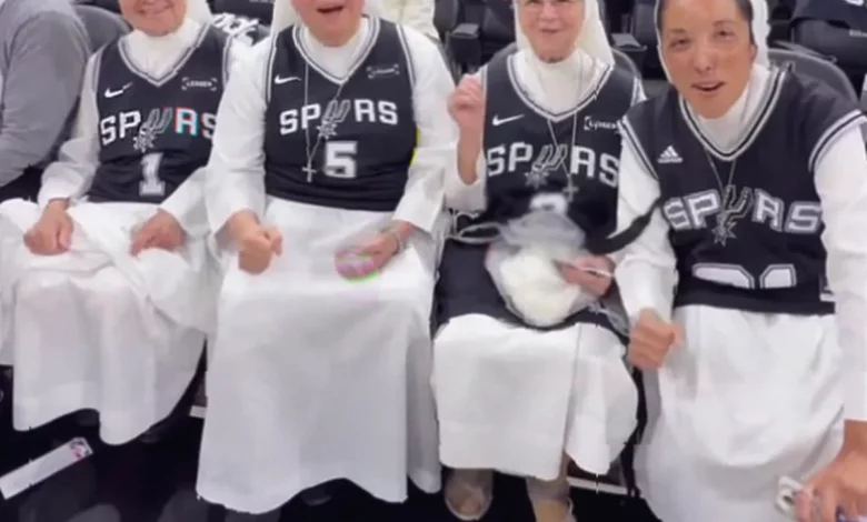 Courtside nuns bless a basketball player before a playoff game in San Antonio