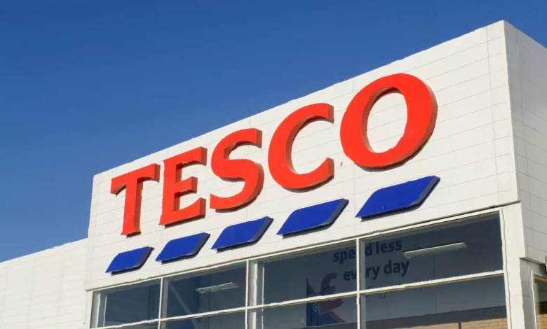 Tesco supermarket exterior with shoppers entering through automatic doors