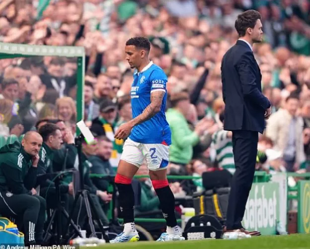 James Tavernier wiping tears while waving to supporters from the touchline