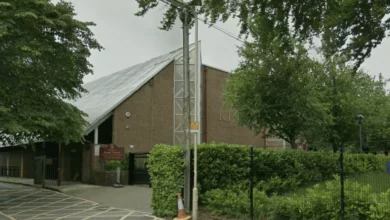 Flowers and candles left at the gates of Kings' School in tribute to a teacher