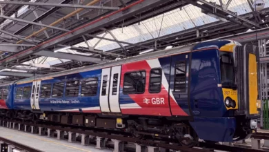 Commuter train arriving at a busy London railway station platform