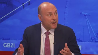 Two politicians in a television studio during a heated debate about Brexit