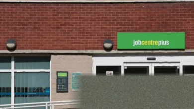 Office workers walking past a job centre in a British city centre
