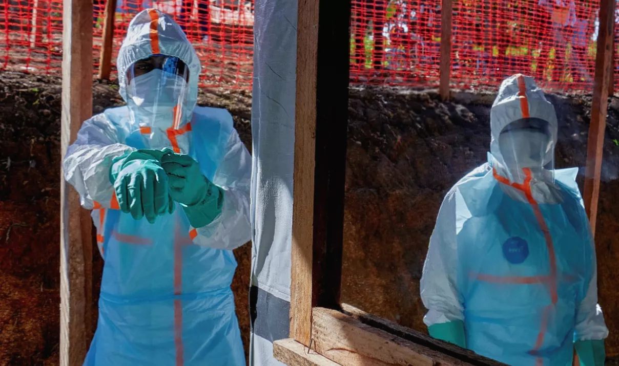Healthcare workers treating patients in protective suits at an Ebola isolation unit in Ituri
