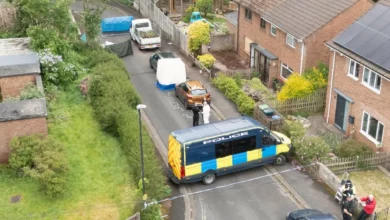 Emergency services gather outside a damaged house on Sterncourt Road in Frenchay, Bristol