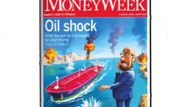 Stack of MoneyWeek print magazines on a desk with a pen