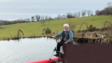 Elderly activist pedals a water-bike on the River Thames near Oxford