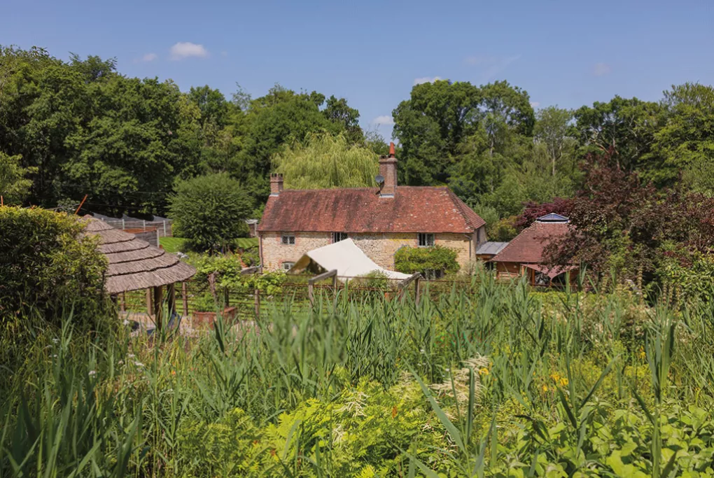 Oak-framed outdoor barbecue kitchen beside a converted Kent oast house and orchards