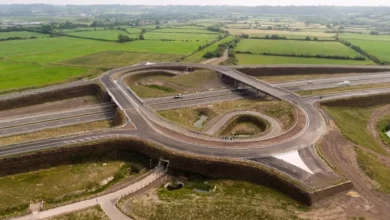 Unused motorway junction and bridges near Bristol, surrounded by greenery and industrial land
