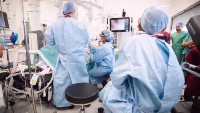 Surgeon viewing a screen with colour-coded tissues during a bowel resection operation