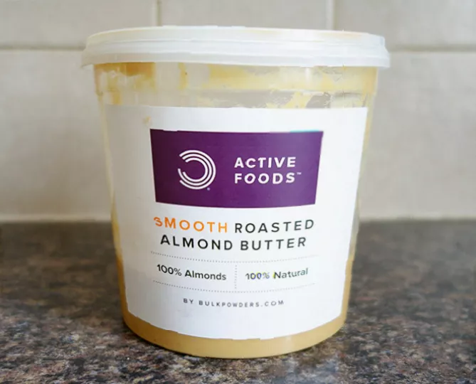 Bowl of mixed calcium-rich foods including almonds, yoghurt, and cheese