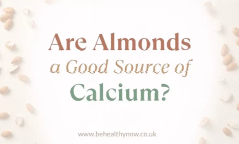 Small handful of almonds on a wooden surface near a glass of cow's milk