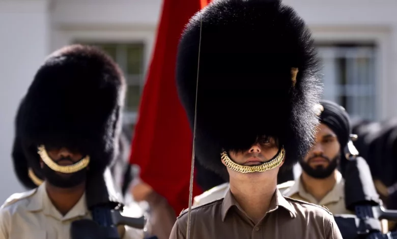 Bearskin caps worn by King's Guards during a ceremonial parade outside Buckingham Palace
