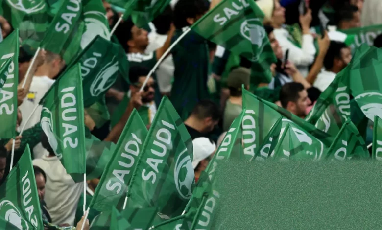 A football stadium with prominent Aramco advertising hoardings around the pitch during a World Cup match