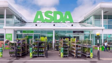 Exterior view of an Asda supermarket on a cloudy day with shoppers entering