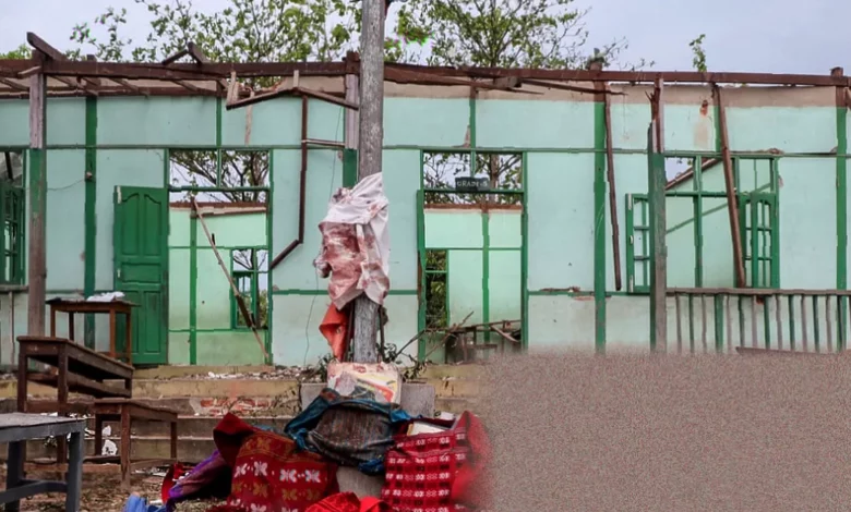 Students walking past a damaged school building in a conflict zone