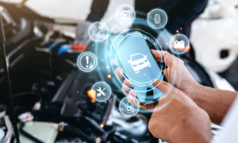 A mechanic in a UK garage using a tablet to diagnose a car's engine fault
