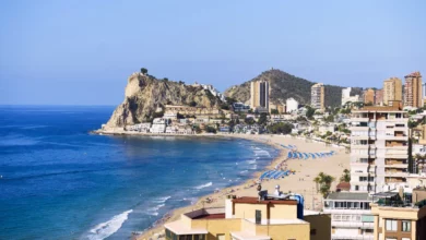 Crowded beach in Benidorm with sunbathers and a lifeguard station in background