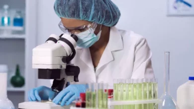 Laboratory scientist pipetting reagents from a biochemical supply container