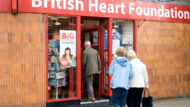 A closed British Heart Foundation charity shop with a sign directing customers to another store