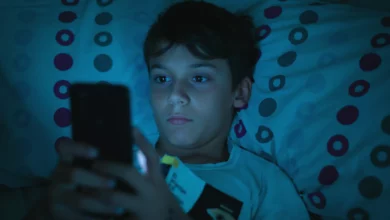 Child sleeping in a darkened bedroom with soft nightlight