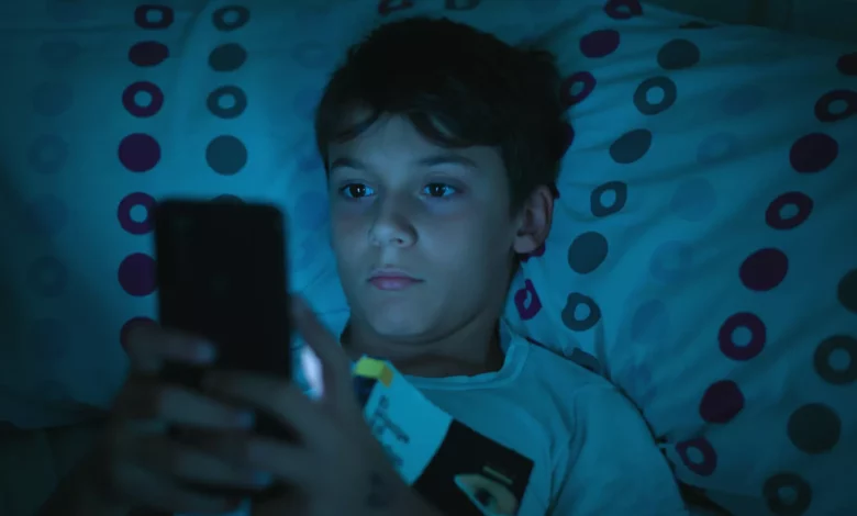 Child sleeping in a darkened bedroom with soft nightlight
