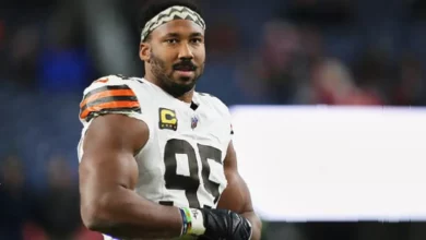 American football defensive end Myles Garrett in motion on a grass field during an NFL game