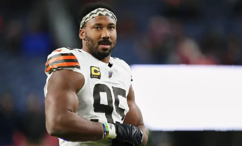 American football defensive end Myles Garrett in motion on a grass field during an NFL game
