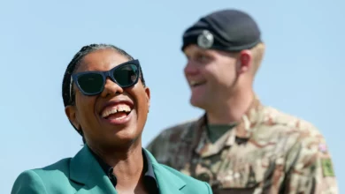 A group of Army Reserve soldiers in camouflage uniform training outdoors on a firing range