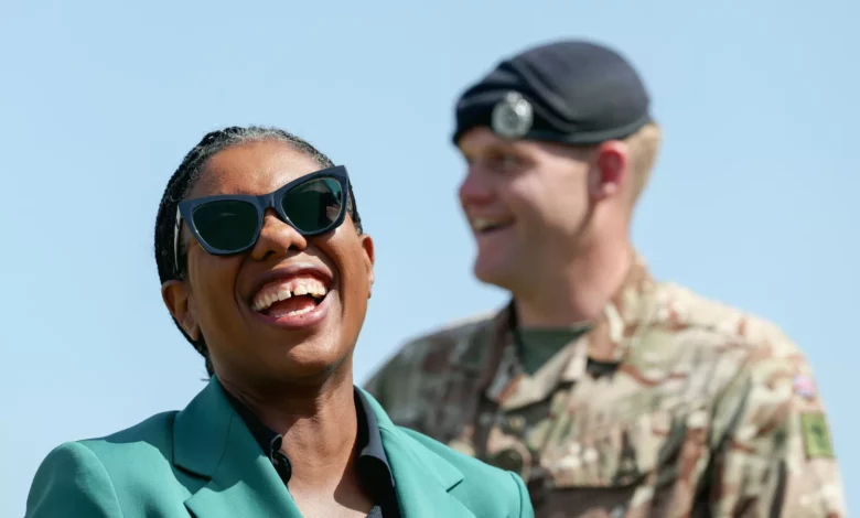 A group of Army Reserve soldiers in camouflage uniform training outdoors on a firing range