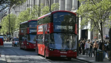 Busy Oxford Street shopping district with red London buses and traffic in central London