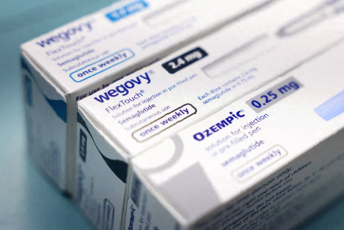 Boxes of Ozempic medication stacked on a pharmaceutical warehouse shelf