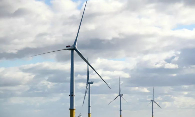Offshore wind turbines rising from the seabed near the UK coastline