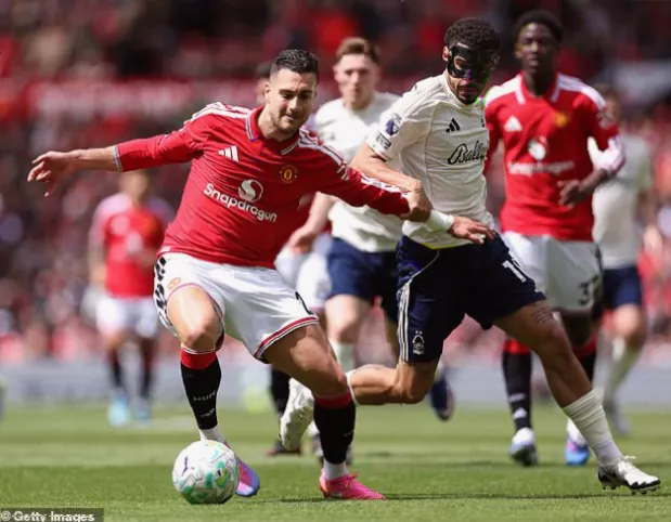 A Manchester United striker celebrating a brace during a Premier League match at Old Trafford