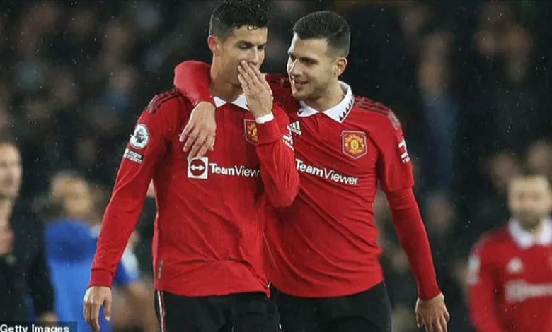 Cristiano Ronaldo in conversation with Diogo Dalot during a Manchester United training session