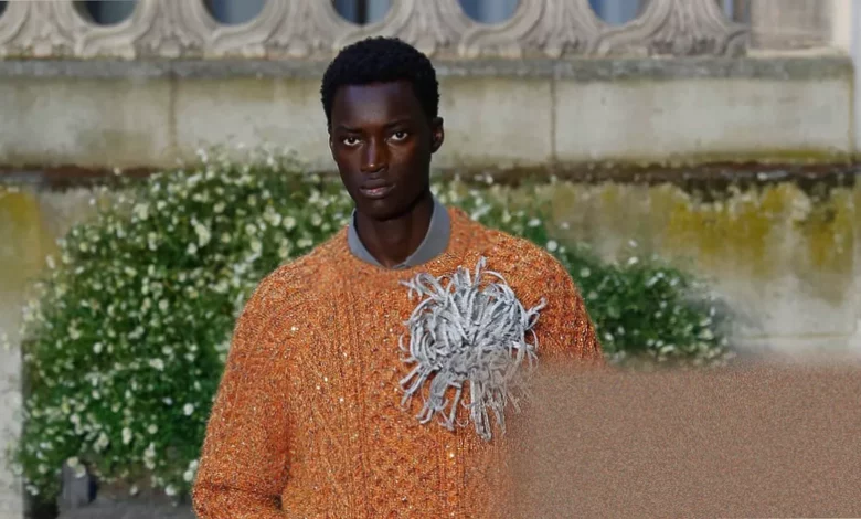 Early morning Dior fashion show in a Paris garden under bright sunlight with guests using handheld fans