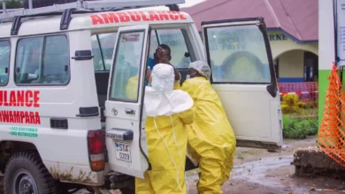 Medical workers in protective suits preparing an isolation unit at a French hospital