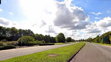 A grey Peugeot 508 after a head-on collision with a green Fiat 500 on a roadside in Milton Keynes.
