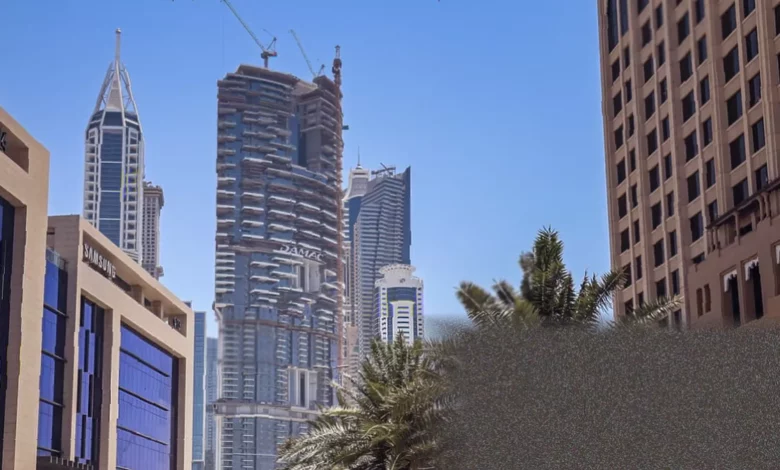 Aerial view of Dubai skyline with Palm Jumeirah and luxury towers under hazy skies