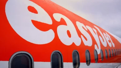 EasyJet aircraft parked on a tarmac at a UK airport in summer sunlight