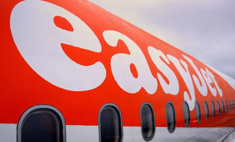 EasyJet aircraft parked on a tarmac at a UK airport in summer sunlight