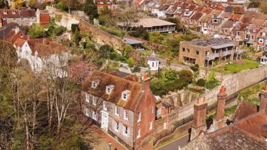 Exterior of a Georgian house with a symmetrical grey brick facade and large sash windows in Lewes, East Sussex.