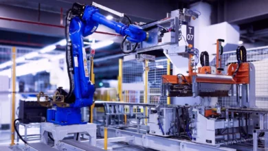 Factory floor with modern machinery and workers monitoring production lines