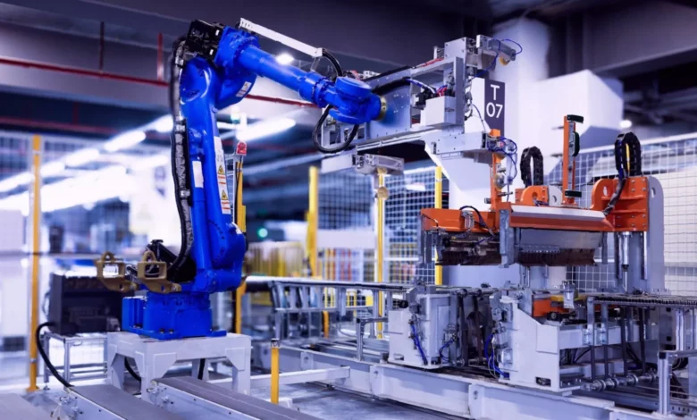 Factory floor with modern machinery and workers monitoring production lines
