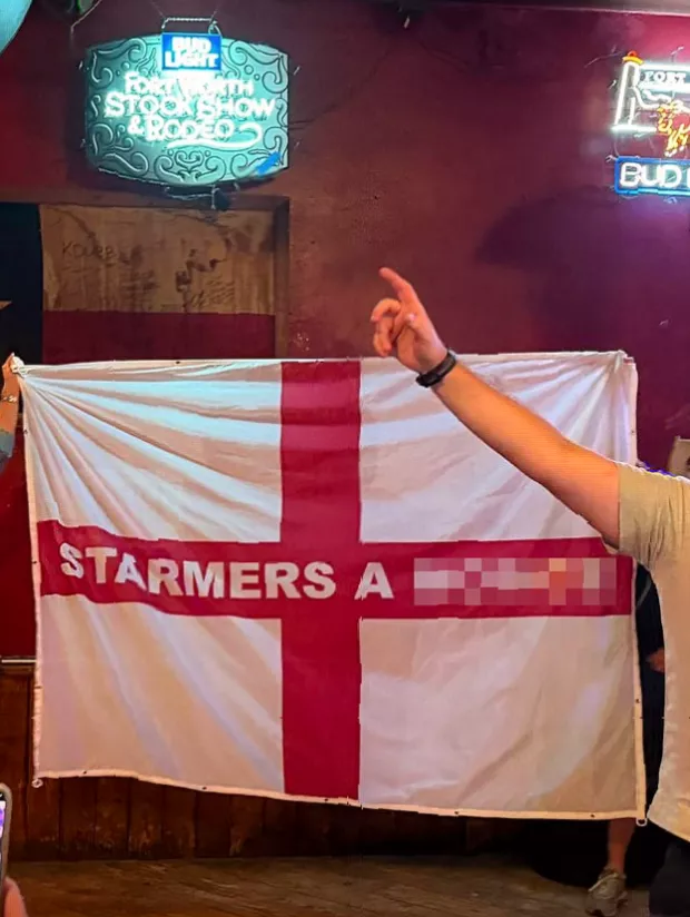Crowd of England fans singing in a bar at the Fort Worth Stockyards