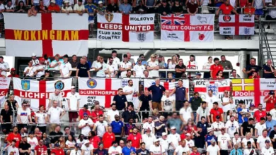 England supporter holding a St George's Cross outside a stadium in Dallas
