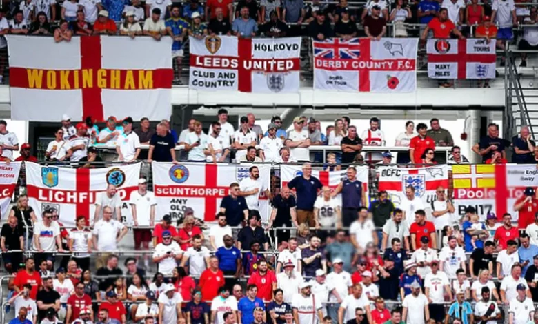 England supporter holding a St George's Cross outside a stadium in Dallas